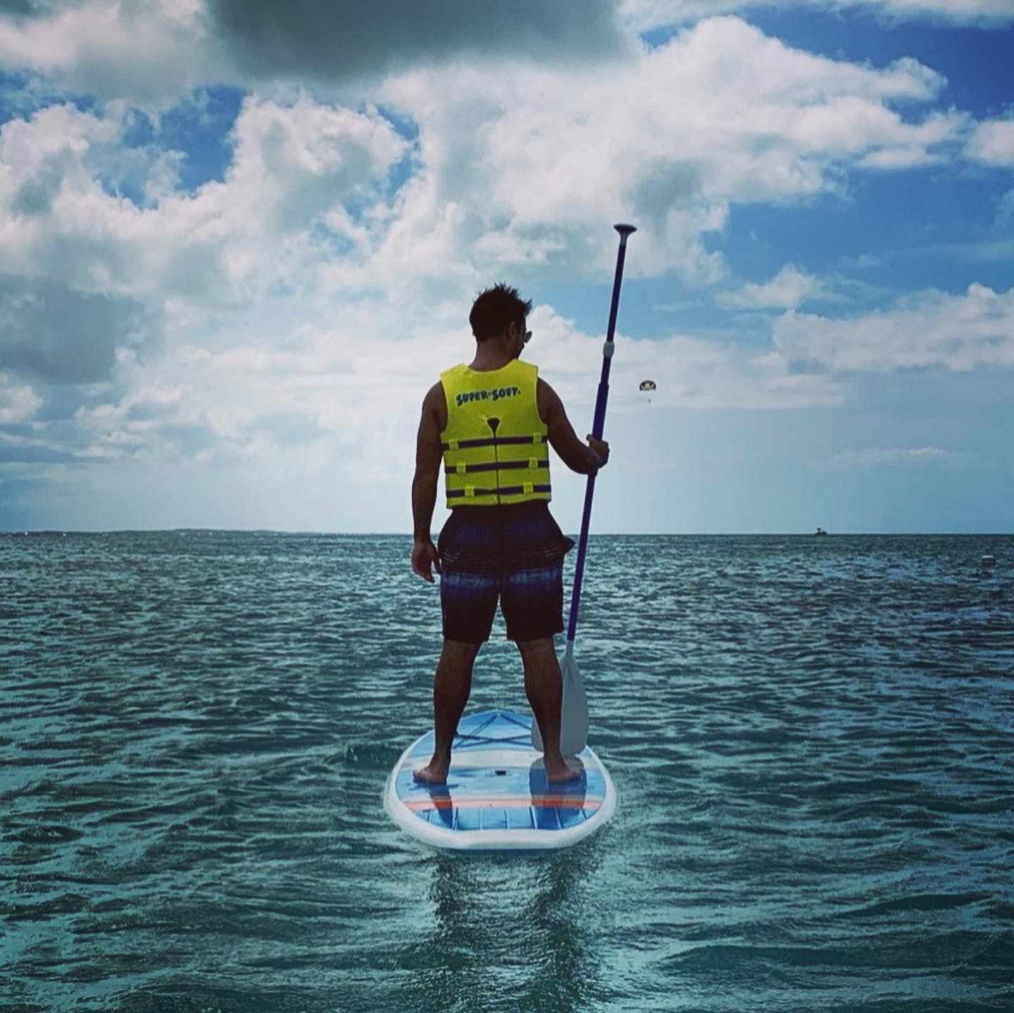 Tejas paddleboarding on the ocean